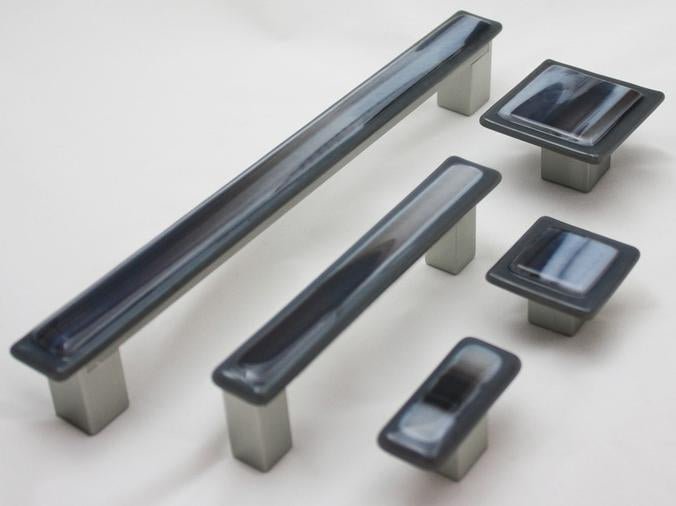 Display of black cabinet knobs and pulls in various sizes.