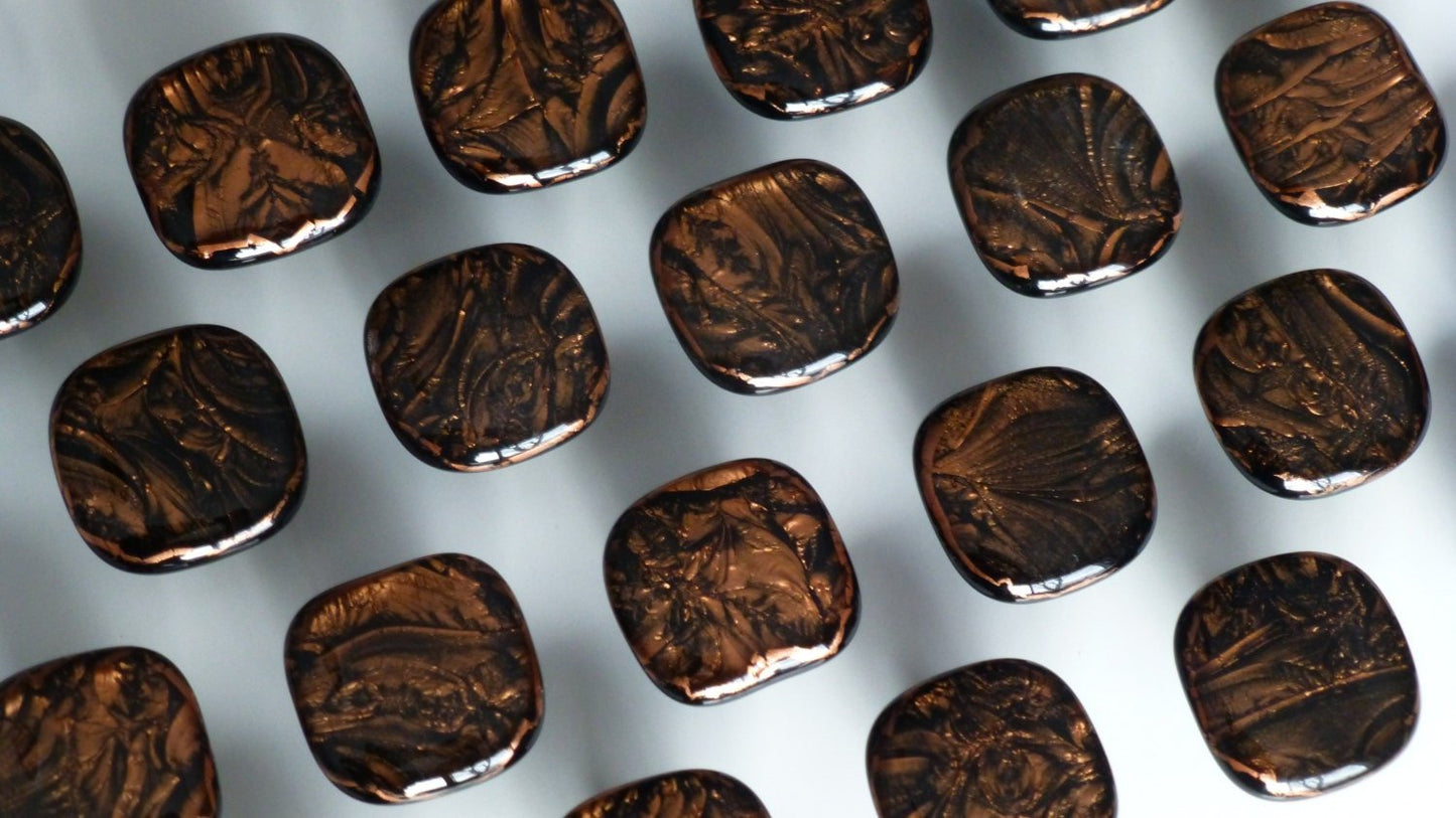 A display of multiple copper cabinet hardware pulls that show off the unique frost patterns. Made in USA. Ann Ivory Studios.